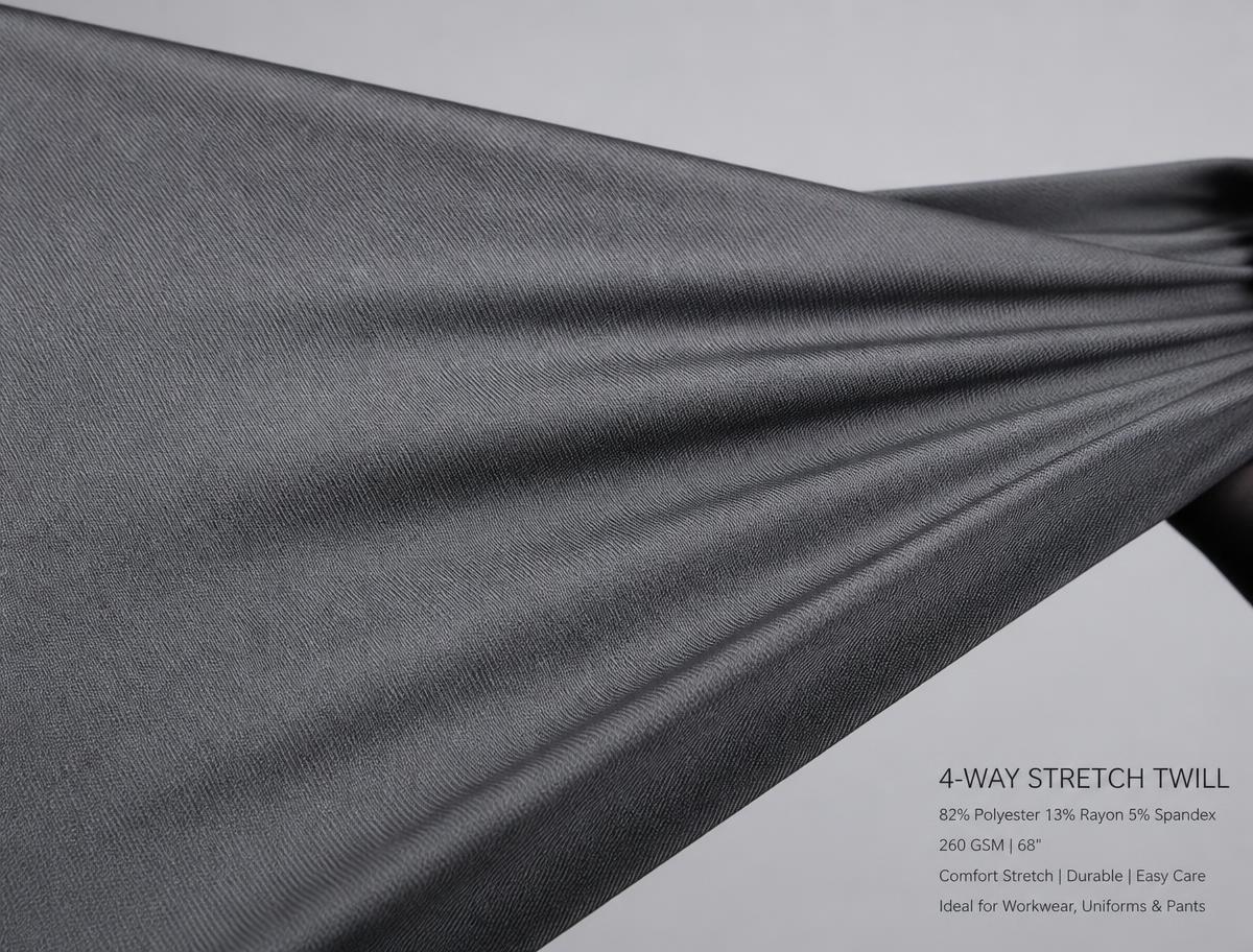 Grey stretch workwear fabric pulled taut to demonstrate elasticity and twill texture